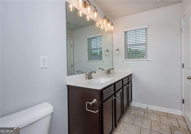 2539 Hedgeway Cir, Kennesaw, GA 30144 - full bathroom with baseboards, a sink, double vanity, and toilet