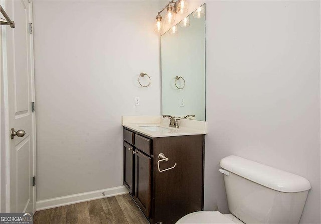 2539 Hedgeway Cir, Kennesaw, GA 30144 - bathroom with vanity, baseboards, wood finished floors, and toilet