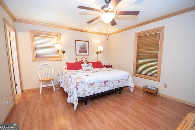 bedroom featuring ceiling fan, light wood finished floors, baseboards, visible vents, and ornamental molding
