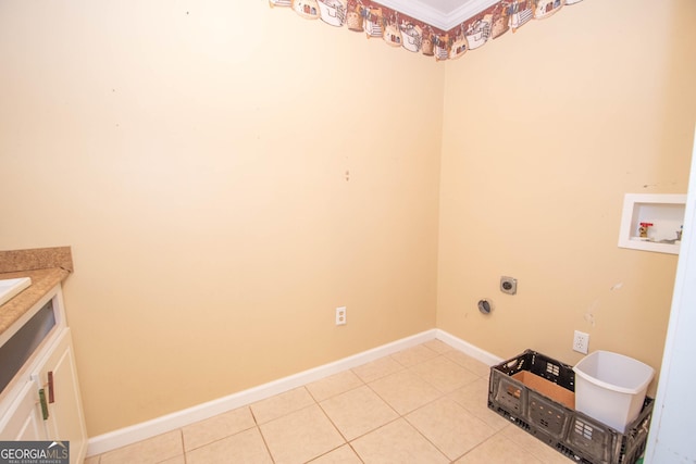 clothes washing area featuring hookup for an electric dryer, laundry area, crown molding, light tile patterned floors, and hookup for a washing machine