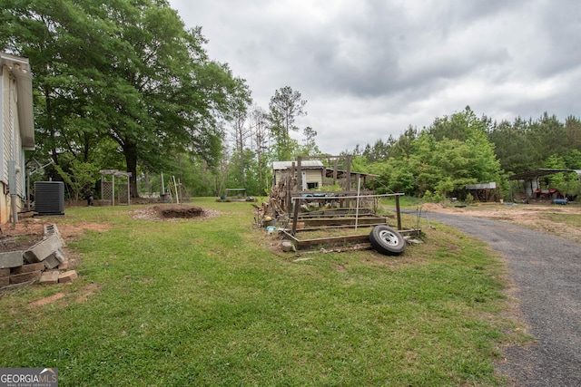 view of yard with cooling unit and a detached carport