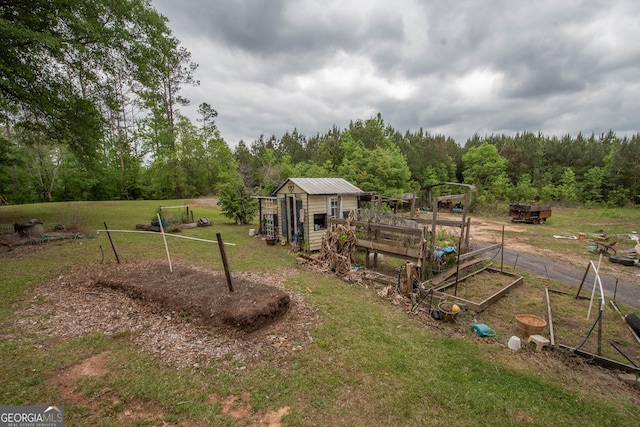view of yard with an outdoor structure and a forest view