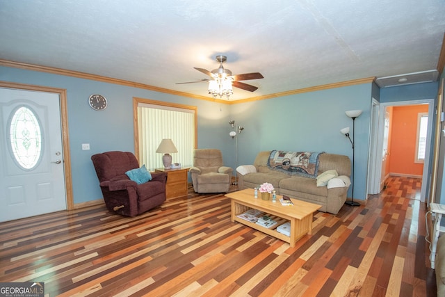 living area featuring baseboards, ceiling fan, wood finished floors, and a wealth of natural light