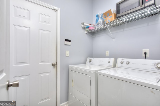 laundry room featuring laundry area, baseboards, and washer and dryer