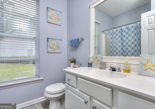 bathroom with vanity, baseboards, a shower with curtain, and toilet