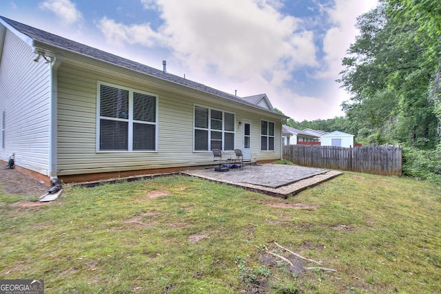 back of house with a lawn, fence, and a patio area