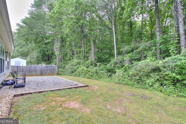 view of yard with fence and a patio area