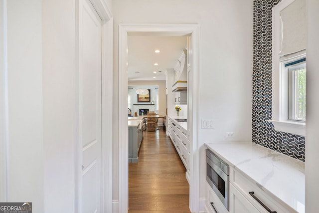 corridor featuring recessed lighting and wood finished floors