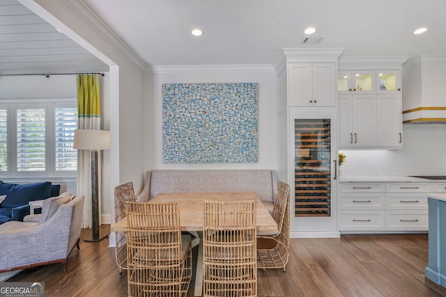 dining area with visible vents, crown molding, dark wood finished floors, wine cooler, and recessed lighting