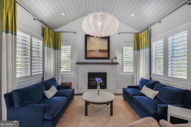living area featuring wooden ceiling, vaulted ceiling, and a stone fireplace