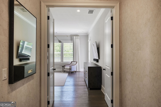 corridor featuring crown molding, baseboards, visible vents, and dark wood-style floors