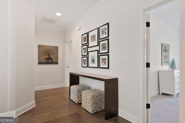 hall featuring dark wood-style flooring, visible vents, crown molding, baseboards, and recessed lighting