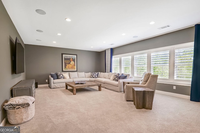 living room with baseboards, light colored carpet, and visible vents