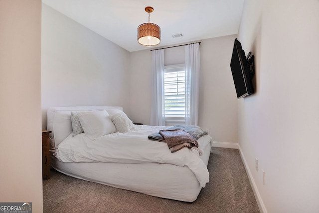bedroom with carpet floors, baseboards, and visible vents