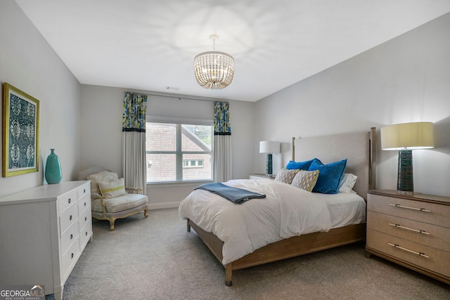 bedroom with baseboards, a chandelier, and light colored carpet