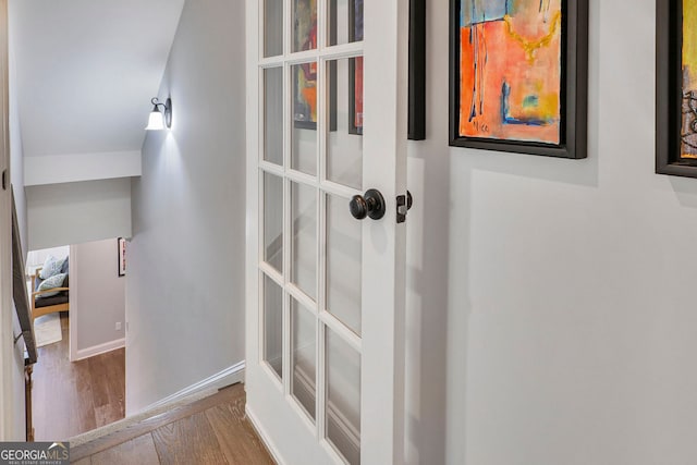 interior space with baseboards and wood finished floors