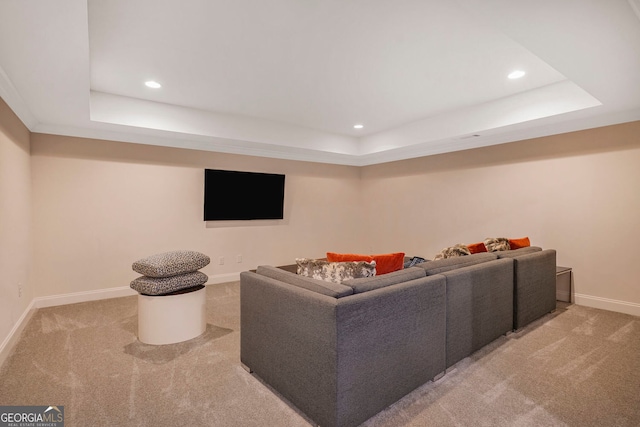 living area with recessed lighting, a tray ceiling, and light carpet