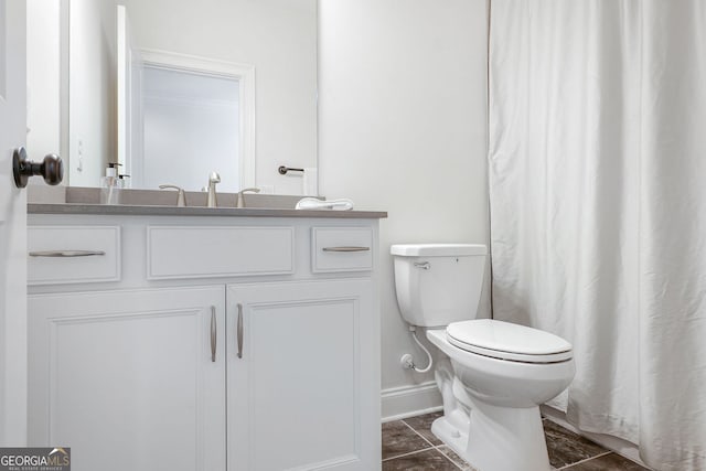 full bath featuring vanity, baseboards, and toilet
