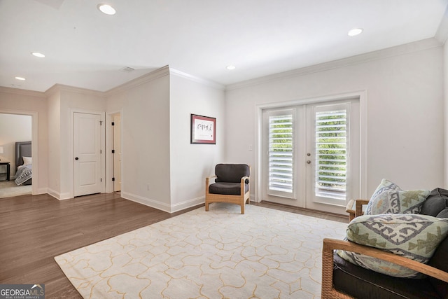 living area featuring french doors, recessed lighting, crown molding, and wood finished floors