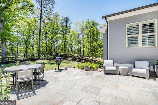 view of patio / terrace with a fenced backyard, outdoor dining space, and a grill