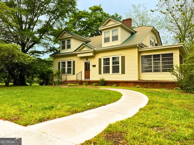 view of front of home featuring a front yard and a chimney