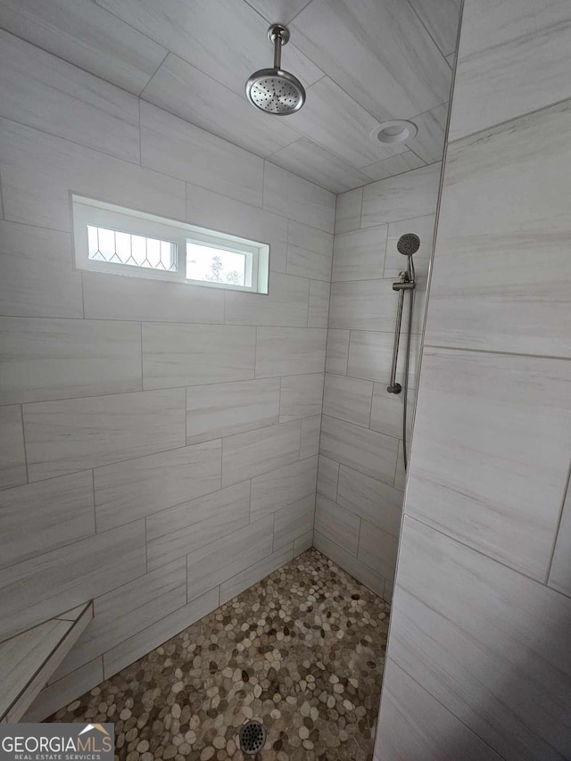 bathroom with a tile shower
