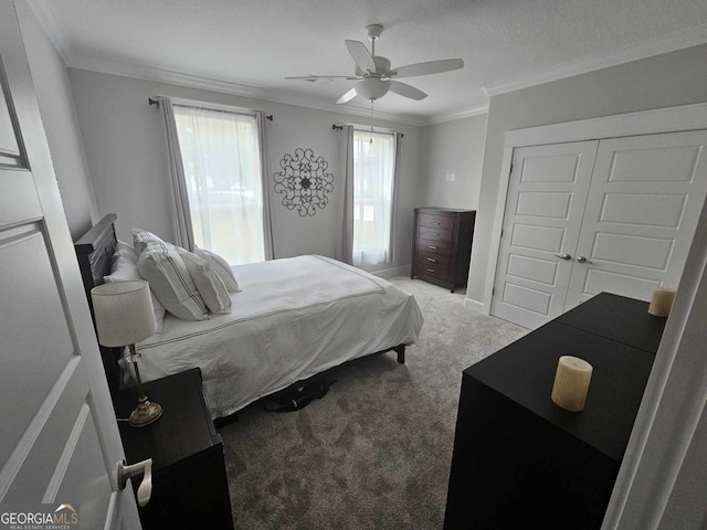 bedroom with a ceiling fan, baseboards, a closet, ornamental molding, and light carpet