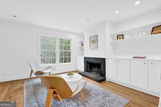 11 Ardmore Sq NW, Atlanta, GA 30309 - living room featuring ornamental molding, a premium fireplace, light wood-type flooring, baseboards, and recessed lighting