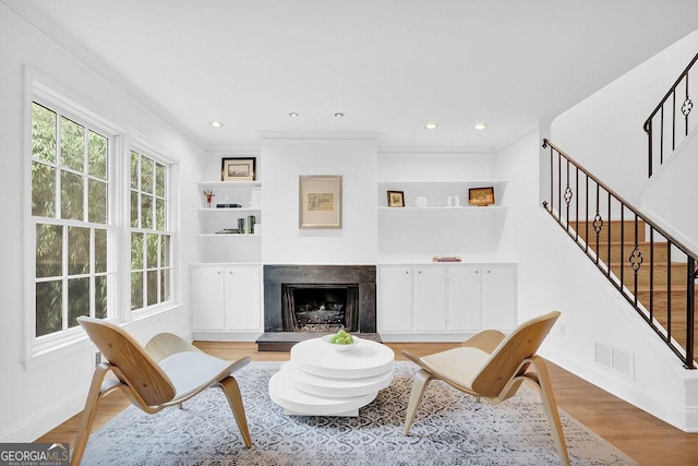 11 Ardmore Sq NW, Atlanta, GA 30309 - living area featuring stairway, baseboards, a high end fireplace, wood finished floors, and crown molding