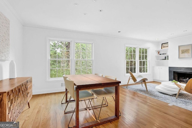 11 Ardmore Sq NW, Atlanta, GA 30309 - dining area featuring ornamental molding, light wood-style floors, baseboards, and a fireplace