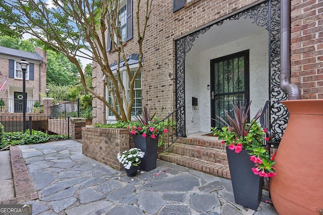 11 Ardmore Sq NW, Atlanta, GA 30309 - doorway to property featuring stucco siding and brick siding