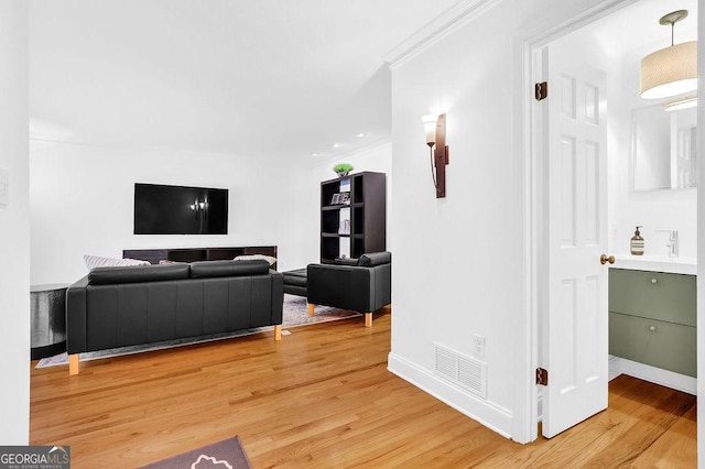 11 Ardmore Sq NW, Atlanta, GA 30309 - living area with light wood-style floors, crown molding, and baseboards