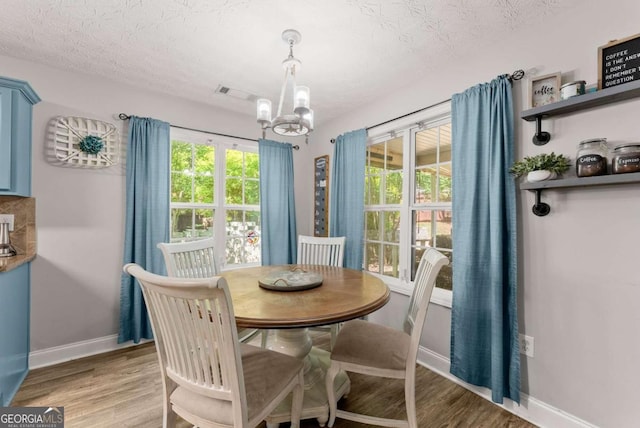 1338 Jefferson Station Rd, Jefferson, GA 30549 - dining area featuring a chandelier, light wood-style flooring, and a textured ceiling
