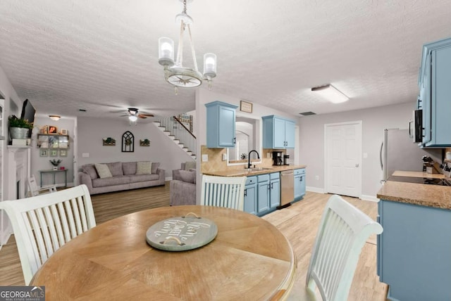 1338 Jefferson Station Rd, Jefferson, GA 30549 - dining room with stairway, light wood-type flooring, a ceiling fan, and a textured ceiling