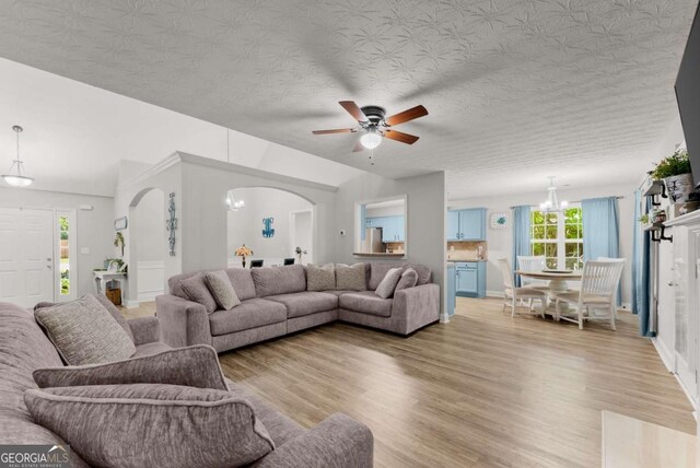 1338 Jefferson Station Rd, Jefferson, GA 30549 - living room with light wood finished floors, arched walkways, ceiling fan, and healthy amount of natural light