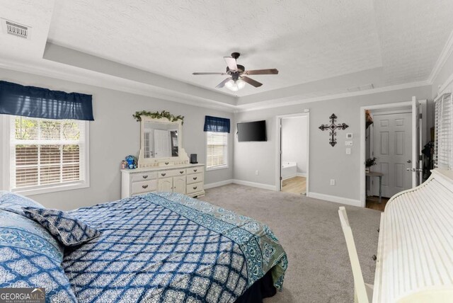 1338 Jefferson Station Rd, Jefferson, GA 30549 - carpeted bedroom featuring a raised ceiling, ceiling fan, crown molding, and ensuite bathroom