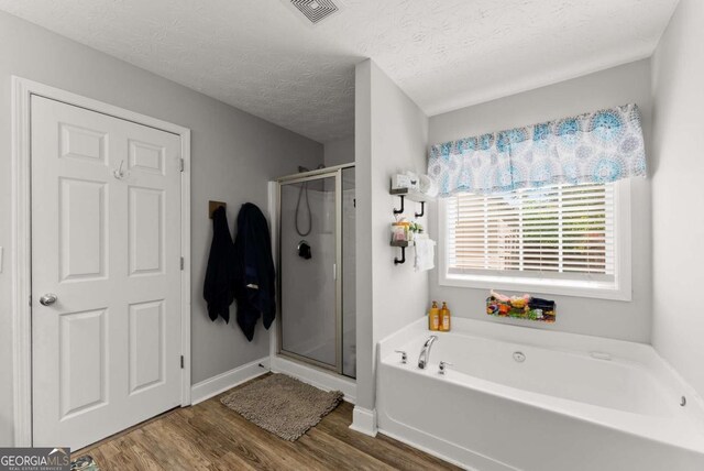 1338 Jefferson Station Rd, Jefferson, GA 30549 - ensuite bathroom featuring double vanity, ceiling fan, wood finished floors, a textured ceiling, and an enclosed shower
