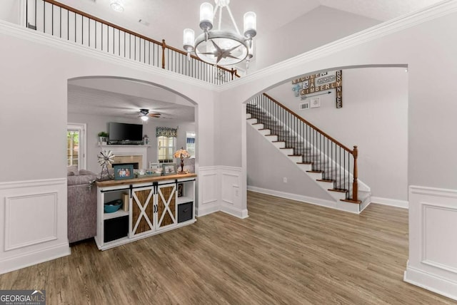 1338 Jefferson Station Rd, Jefferson, GA 30549 - bar area with stairway, wood finished floors, arched walkways, a ceiling fan, and a chandelier