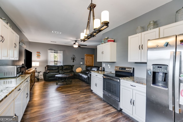 kitchen with a ceiling fan, stainless steel appliances, dark wood-style floors, and open floor plan