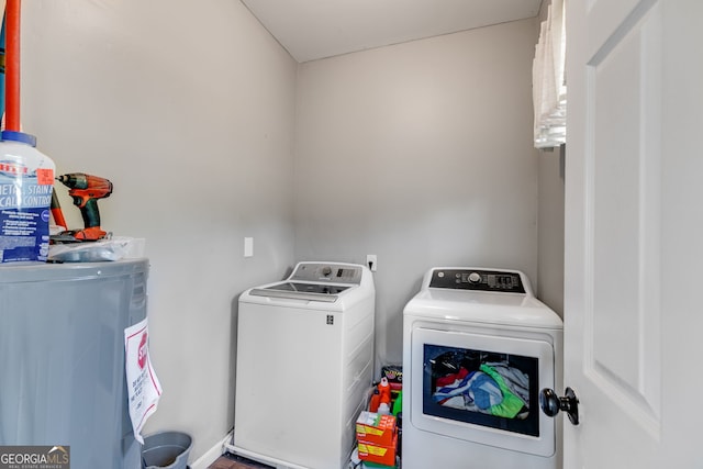 laundry room featuring laundry area, washing machine and dryer, and water heater