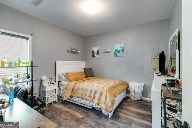 bedroom with dark wood-type flooring and visible vents