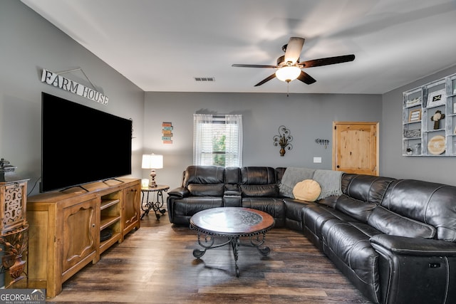 living room featuring visible vents, dark wood-style flooring, and ceiling fan