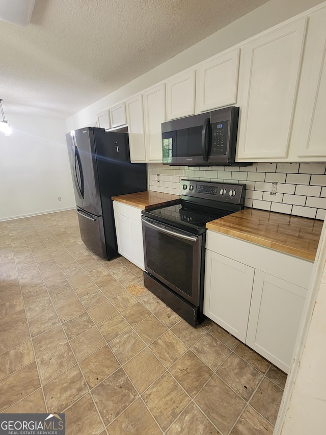 129 Carolyn Path, Rockmart, GA 30153 - kitchen with appliances with stainless steel finishes, wooden counters, backsplash, a textured ceiling, and white cabinetry
