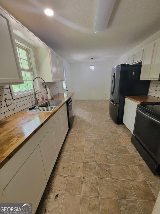 129 Carolyn Path, Rockmart, GA 30153 - kitchen with butcher block counters, black appliances, a sink, white cabinetry, and a textured ceiling