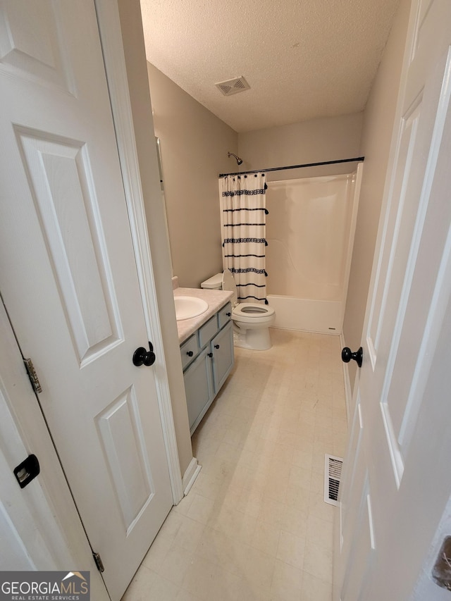129 Carolyn Path, Rockmart, GA 30153 - full bathroom featuring a textured ceiling, toilet, vanity, shower / bath combination with curtain, and tile patterned floors