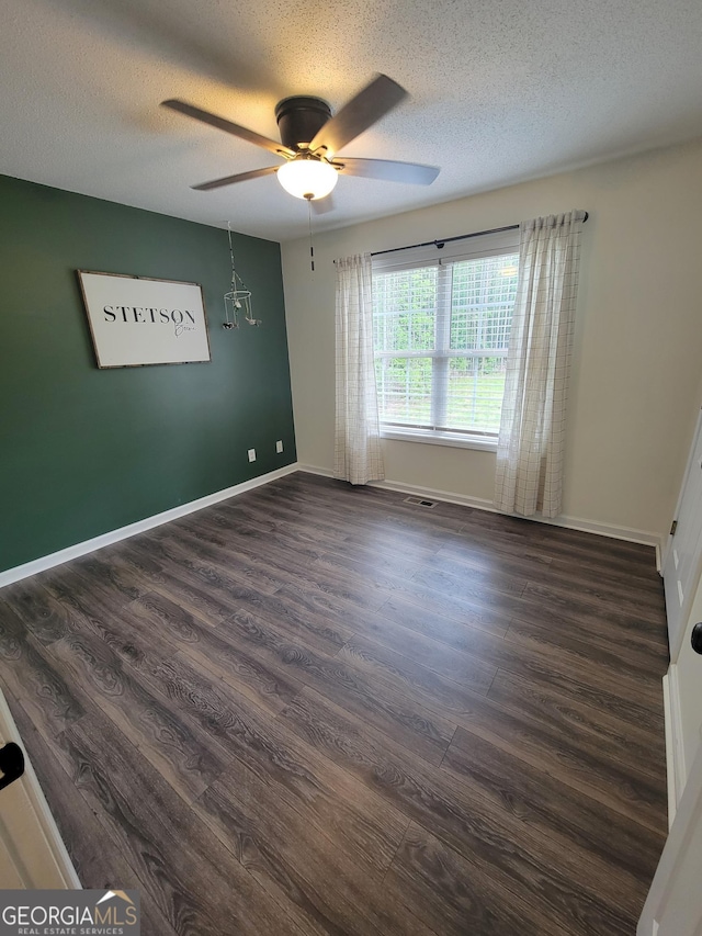 129 Carolyn Path, Rockmart, GA 30153 - empty room featuring dark wood-type flooring, a ceiling fan, a textured ceiling, and baseboards