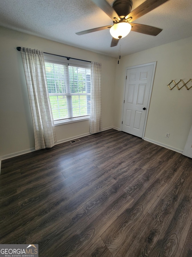 129 Carolyn Path, Rockmart, GA 30153 - spare room with dark wood finished floors, a ceiling fan, baseboards, and a textured ceiling