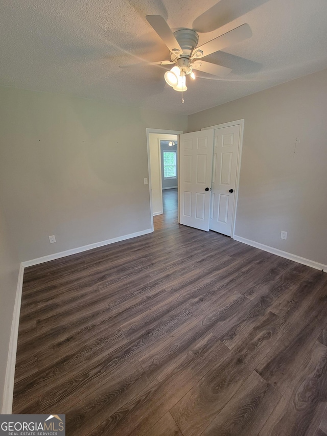 129 Carolyn Path, Rockmart, GA 30153 - unfurnished bedroom with dark wood finished floors, baseboards, and a ceiling fan