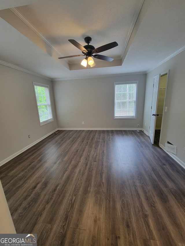 129 Carolyn Path, Rockmart, GA 30153 - unfurnished room with a raised ceiling, crown molding, healthy amount of natural light, and dark wood-type flooring