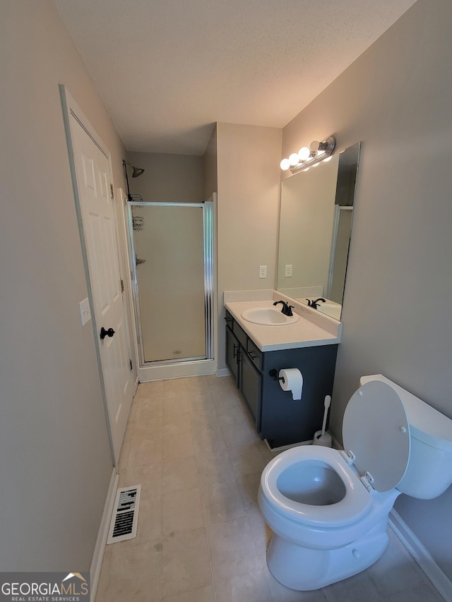 129 Carolyn Path, Rockmart, GA 30153 - full bathroom with a shower stall, toilet, vanity, baseboards, and a textured ceiling